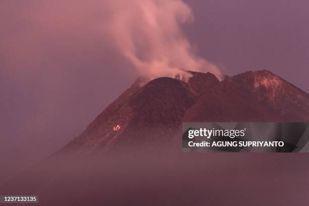 Smoke rises from Mount Merapi, Indonesias most active volcano, from its peak as seen from Sleman near Yogyakarta on December 10, 2021.