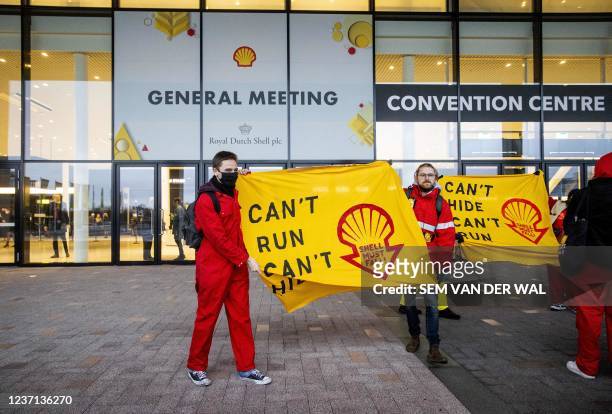 Environment activists protest during an action in front of Shell's headquarters in Rotterdam, ahead of the shareholders' meeting about the move of...