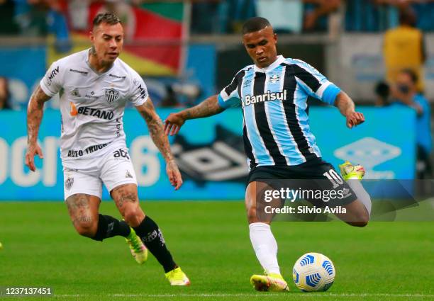 Eduardo Vargas of Atletico Mineiro and Douglas Costa of Gremio fight for the ball during the match between Gremio and Atletico Mineiro as part of...