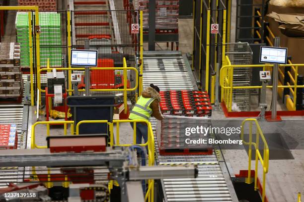 An employee wraps a pallet of KitKat chocolate bars, manufactured by Nestle SA, at a distribution warehouse operated by GXO Logistics Inc. Near...