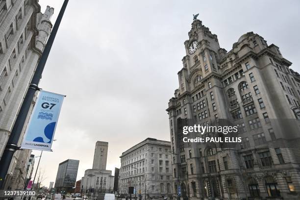 Banners flutter in front of the Liver Building in Liverpool, northwest England on December 10 ahead of the G7 foreign ministers meeting in the city...