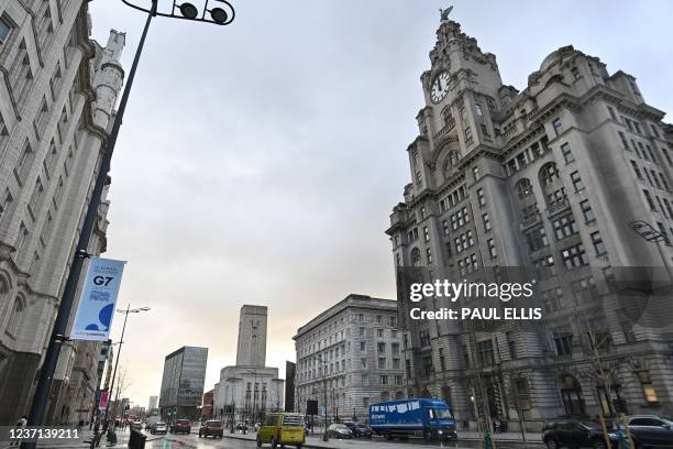 Banners flutter in front of the Liver Building in Liverpool, northwest England on December 10 ahead of the G7 foreign ministers meeting in the city...