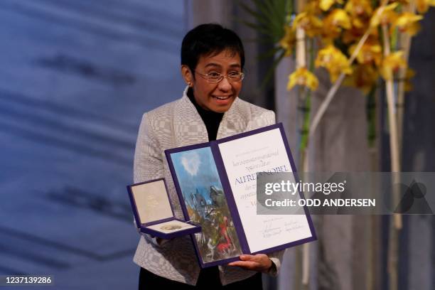 Nobel Peace Prize laureate Maria Ressa of the Philippines poses with the Nobel Peace Prize diploma and medal during the gala award ceremony for the...
