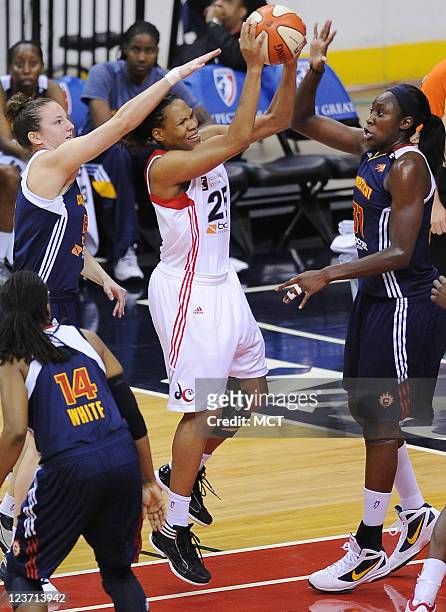 Washington Mystics forward Monique Currie takes the ball up against Connecticut Sun forward Kelsey Griffin , left, and Sun center Tina Charles during...