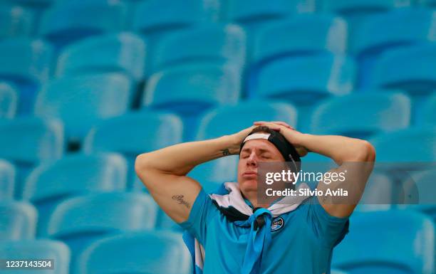 Fan of Gremio reacts after Gremio was relegated to Serie B after the match between Gremio and Atletico Mineiro as part of Brasileirao Series A at...