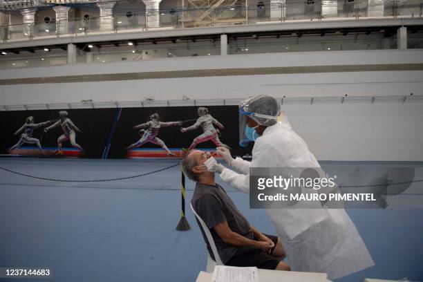 Patient gets a COVID-19 swab test during a medical treatment at the Health Care Center specialized in Flu and COVID-19 located at the Rio 2016's...