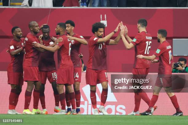 Qatar's forward Almoez Ali celebrates with his team after scoring the second goal during the FIFA Arab Cup 2021 quarter final football match between...