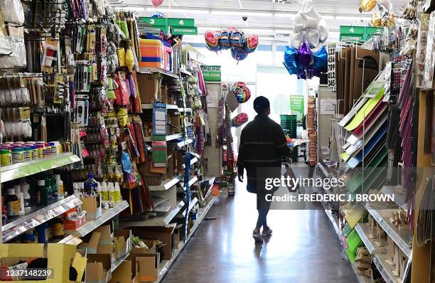 Shopper walks through the aisles of the Dollar Tree store in Alhambra, California on December 10, 2021. - The store is known for its $1 items, but...