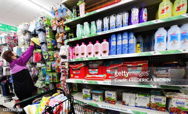 Woman shops at the Dollar Tree store in Alhambra, California, December 10, 2021. - The store is known for its $1 items, but this week, due to...