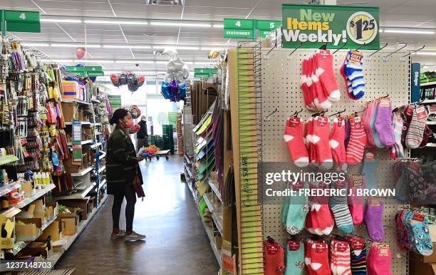 Woman shops at the Dollar Tree store where $1.25 price tags are now posted on the shelves, in Alhambra, California, December 10, 2021. - The store is...