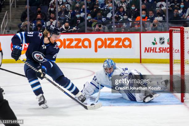 Kyle Connor of the Winnipeg Jets moves in for the shot while goaltender Joseph Woll of the Toronto Maple Leafs guards the net during second period...