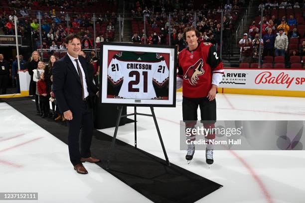 Loui Eriksson of the Arizona Coyotes is presented a framed jersey by Coyote's Chief Hockey Development Officer Shane Doan during a ceremony to...