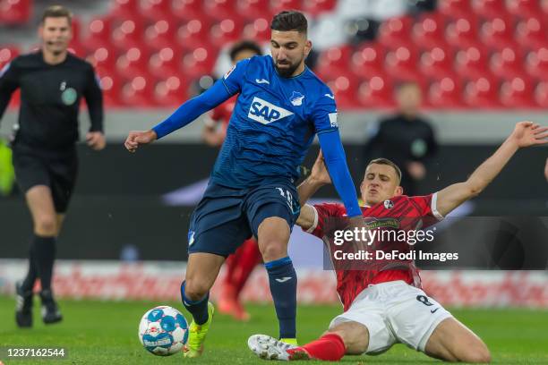 Munas Dabbur of TSG 1899 Hoffenheim and Maximilian Eggestein of SC Freiburg battle for the ball during the Bundesliga match between Sport-Club...