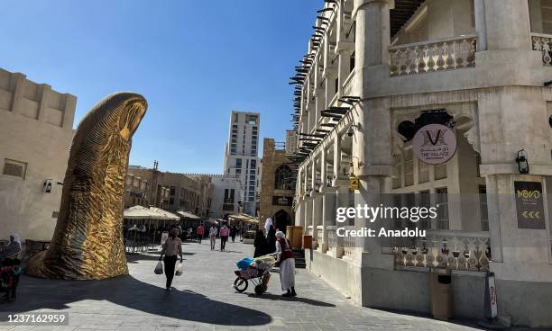 View of the Golden Thumb Satatue in the streets of Souq Waqif, a marketplace in Doha, capital and most populous city of Qatar on December 6, 2021....