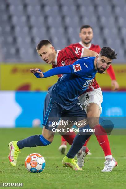 Munas Dabbur of TSG 1899 Hoffenheim and Maximilian Eggestein of SC Freiburg battle for the ball during the Bundesliga match between Sport-Club...