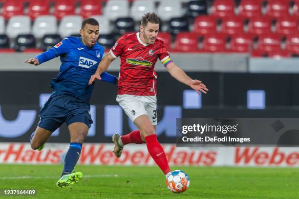 Kevin Akpoguma of TSG 1899 Hoffenheim and Christian Guenter of SC Freiburg battle for the ball during the Bundesliga match between Sport-Club...