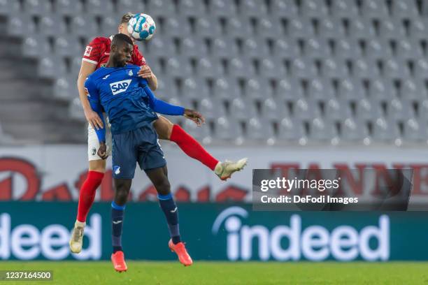 Nico Schlotterbeck of SC Freiburg and Ihlas Bebou of TSG 1899 Hoffenheim battle for the ball during the Bundesliga match between Sport-Club Freiburg...