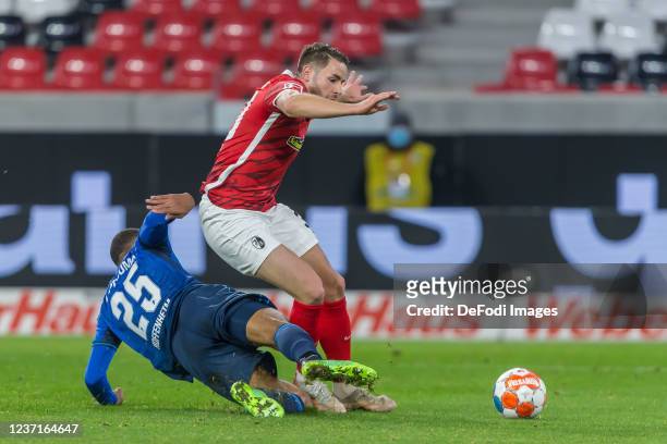 Kevin Akpoguma of TSG 1899 Hoffenheim and Christian Guenter of SC Freiburg battle for the ball during the Bundesliga match between Sport-Club...