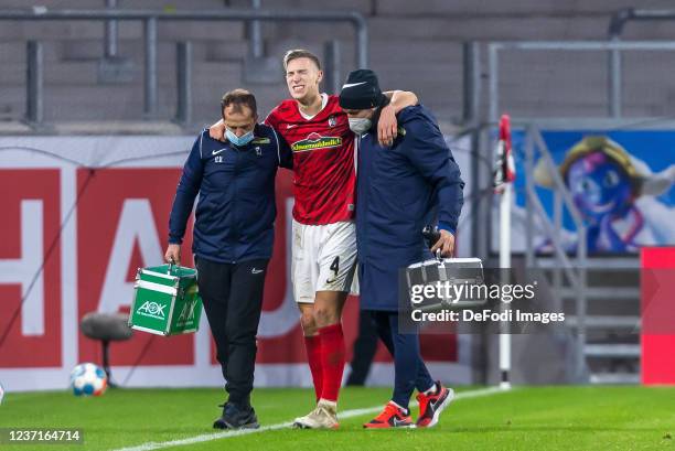 Nico Schlotterbeck of SC Freiburg injured during the Bundesliga match between Sport-Club Freiburg and TSG Hoffenheim at SC-Stadion on December 11,...