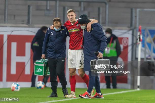 Nico Schlotterbeck of SC Freiburg injured during the Bundesliga match between Sport-Club Freiburg and TSG Hoffenheim at SC-Stadion on December 11,...