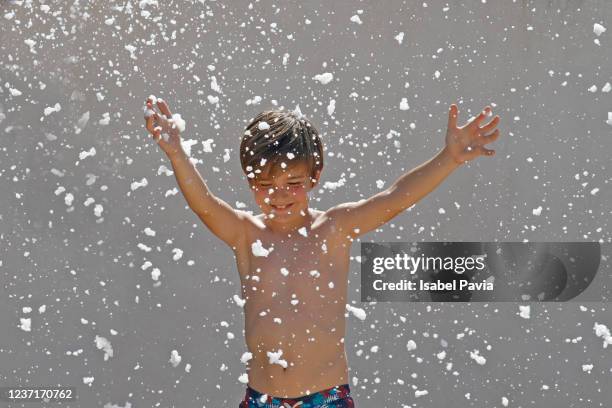 boy having fun with foam at backyard - spray foam stock pictures, royalty-free photos & images