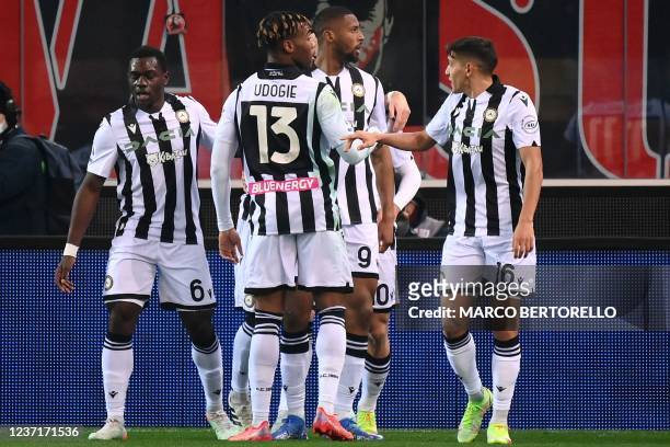 Udinese's Portuguese forward Beto celebrates with teammates after scoring his team's first goal during the Serie A football match between Udinese and...