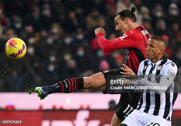 Milan's Swedish forward Zlatan Ibrahimovic kicks the ball over Udinese's Brazilian defender Rodrigo during the Italian Serie A football match between...