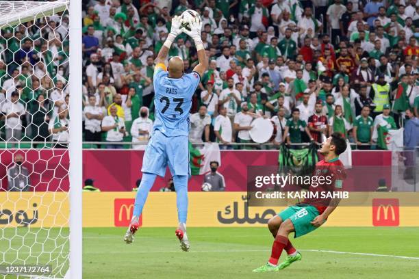 Algeria's goalkeeper Rais M'Bolhi catches the ball during the FIFA Arab Cup 2021 quarter final football match between Morocco and Algeria at the...