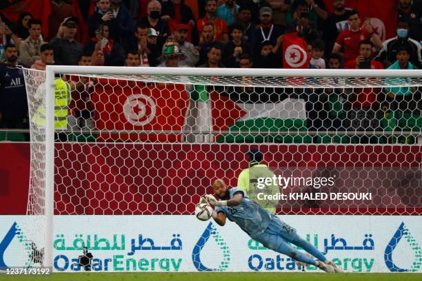 Algeria's goalkeeper Rais M'Bolhi saves a penalty by Morocco's forward Karim el-Berkaoui during the FIFA Arab Cup 2021 quarter final football match...