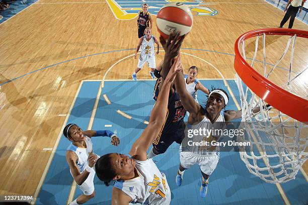 Lindsay Wisdom-Hylton and Sylvia Fowles of the Chicago Sky battle for a rebound with Jessica Davenport of the Indiana Fever during the WNBA game on...