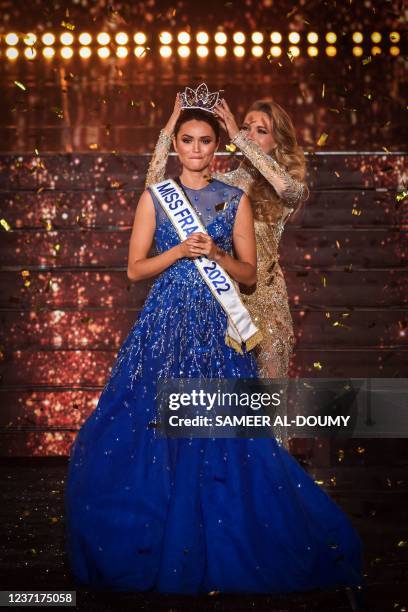 Miss Ile-de-France Diane Leyre is crowned by Miss France 2021 Amandine Petit at the end of the the Miss France 2022 beauty contest in Caen, on...