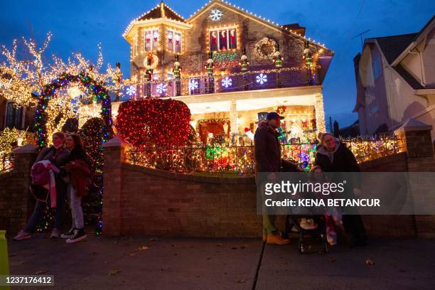 People visit Christmas lights and ornaments in Dyker Heights neighborhood in Brooklyn, New York, on December 11, 2021.