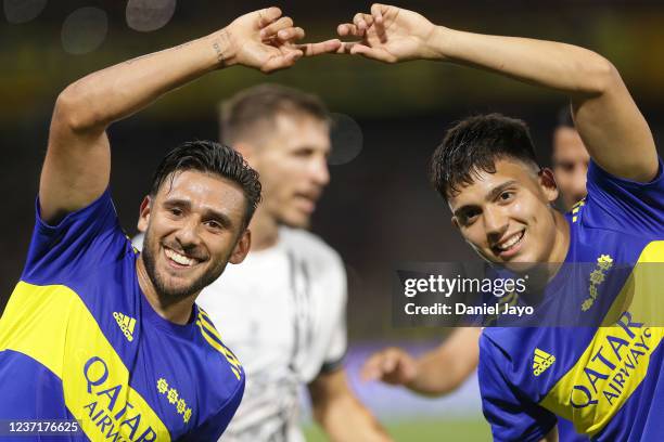 Exequiel Zeballos of Boca Juniors celebrates with teammate Eduardo Salvio after scoring the third goal for his team during a match between Boca...