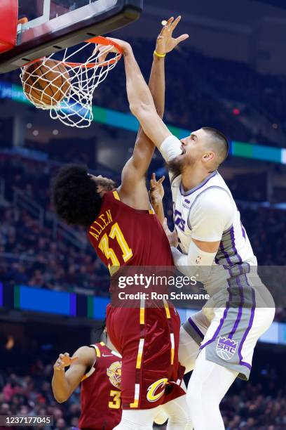 Alex Len of the Sacramento Kings dunks on Jarrett Allen of the Cleveland Cavaliers during the first half at Rocket Mortgage Fieldhouse on December...