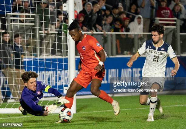 Clemson Tigers goalkeeper George Marks dives at the feet of defender Hamady Diop to cover the ball during a semi-final match at the NCAA Div 1 Mens...