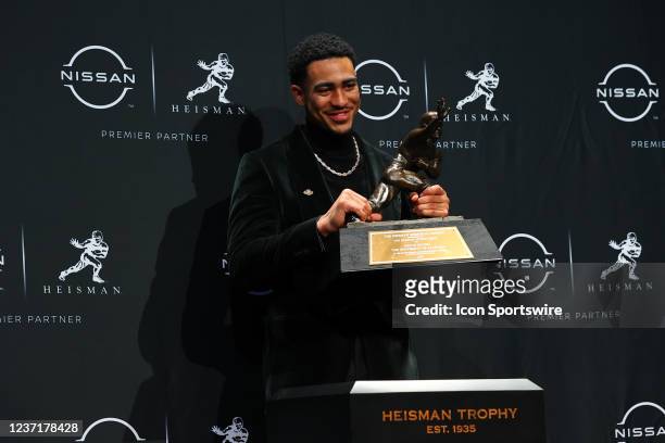 Alabama quarterback Bryce Young poises with the trophy after winning the Heisman Trophy at the press conference at the Marriott Marquis in New York...