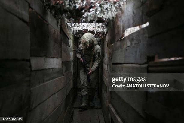 Ukrainian soldier walks along a trench on the frontline with Russia-backed separatists, not far from town of Avdiivka, Donetsk region, on December...