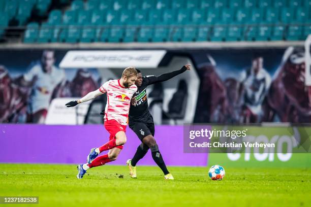 Breel Embolo of Borussia Moenchengladbach and Konard Laimer of Leipzig in action during the Bundesliga match between RB Leipzig and Borussia...