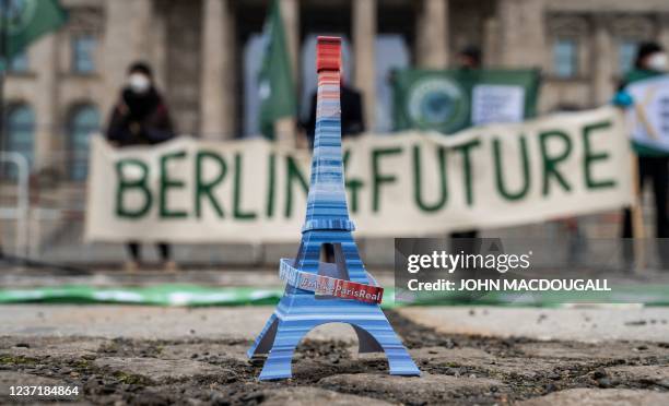 Miniature likeness of the Eiffel Tower, inscribed with the words "Make Paris real", referring to the Paris Agreement on climate change, is placed on...