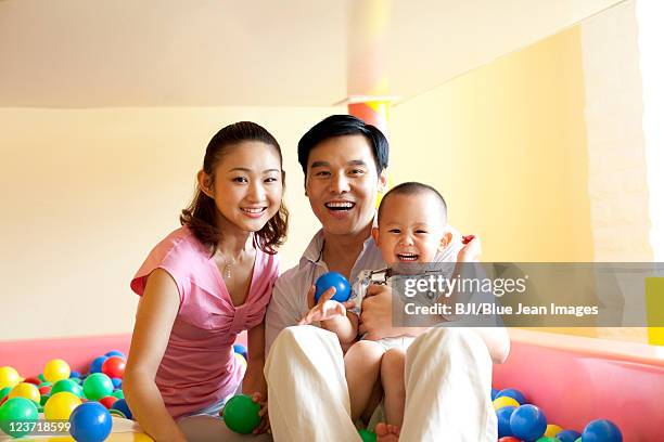 family playing together - adult ball pit stock pictures, royalty-free photos & images