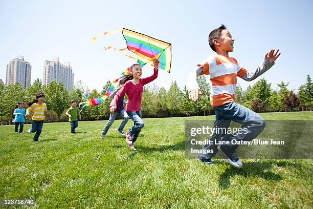 children playing with kite in field - season 5 - fotografias e filmes do acervo