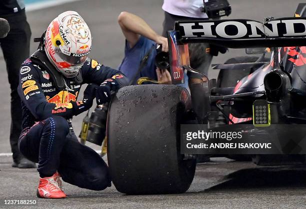 Formula One World Champion Red Bull's Dutch driver Max Verstappen celebrates in the parc ferme of the Yas Marina Circuit after the Abu Dhabi Formula...