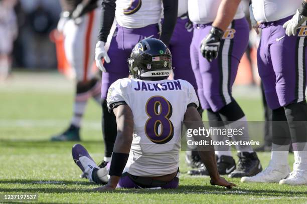 Baltimore Ravens quarterback Lamar Jackson sits on the turf after injuring his ankle during the second quarter of the National Football League game...