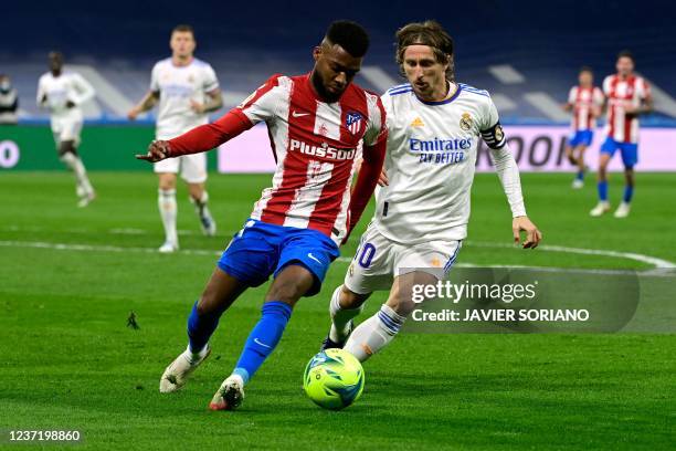 Real Madrid's Croatian midfielder Luka Modric vies with Atletico Madrid's French midfielder Thomas Lemar during the Spanish league football match...