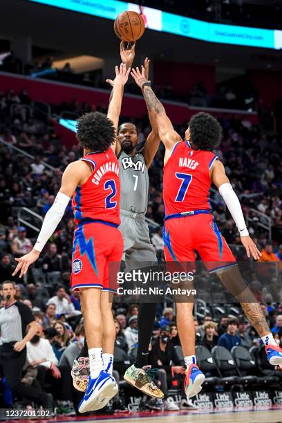 Kevin Durant of the Brooklyn Nets shoots the ball against Cade Cunningham and Killian Hayes of the Detroit Pistons during the first quarter at Little...