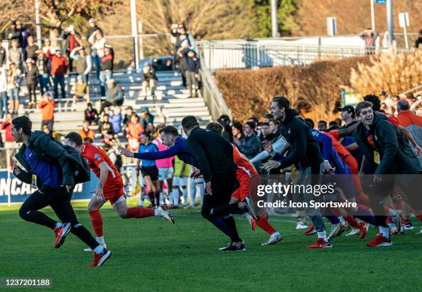 Victorious Clemson bench players race onto the field at the final whistle at the end of the NCAA Div 1 Mens College Cup final between the Washington...