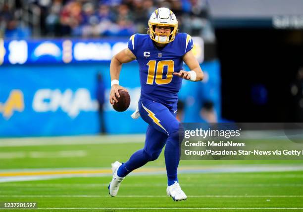 Inglewood, CA Quarterback Justin Herbert of the Los Angeles Chargers scrambles against the New York Giants in the second half of a NFL football game...