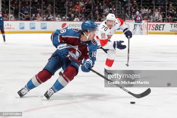 Alex Newhook of the Colorado Avalanche skates against Patric Hornqvist of the Florida Panthers at Ball Arena on December 12, 2021 in Denver, Colorado.