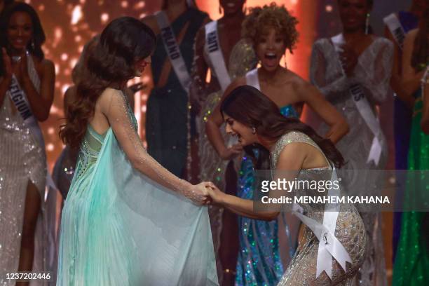 Miss India, Harnaaz Sandhu reacts while holding Miss Paraguay Nadia Ferreira's hands as Miss India is announced winner of the 70th Miss Universe...