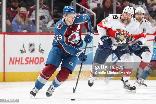 Nathan MacKinnon of the Colorado Avalanche skates against Joe Thornton of the Florida Panthers at Ball Arena on December 12, 2021 in Denver, Colorado.